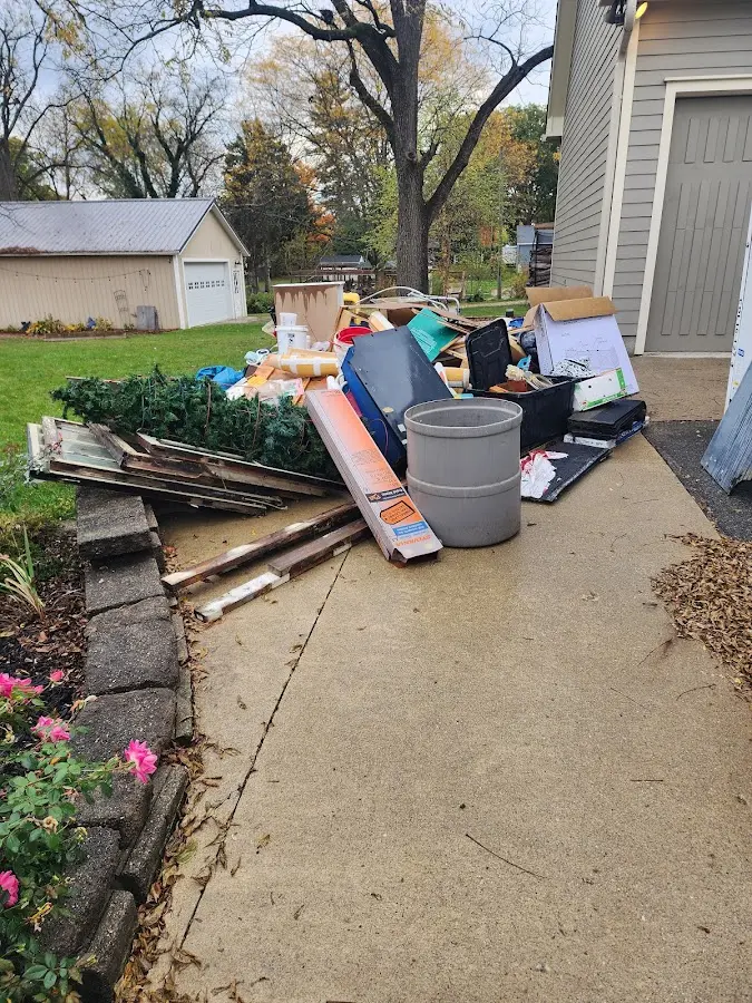Dumpster being loaded with debris for 12 Yard Dumpster Rental in Kilgore